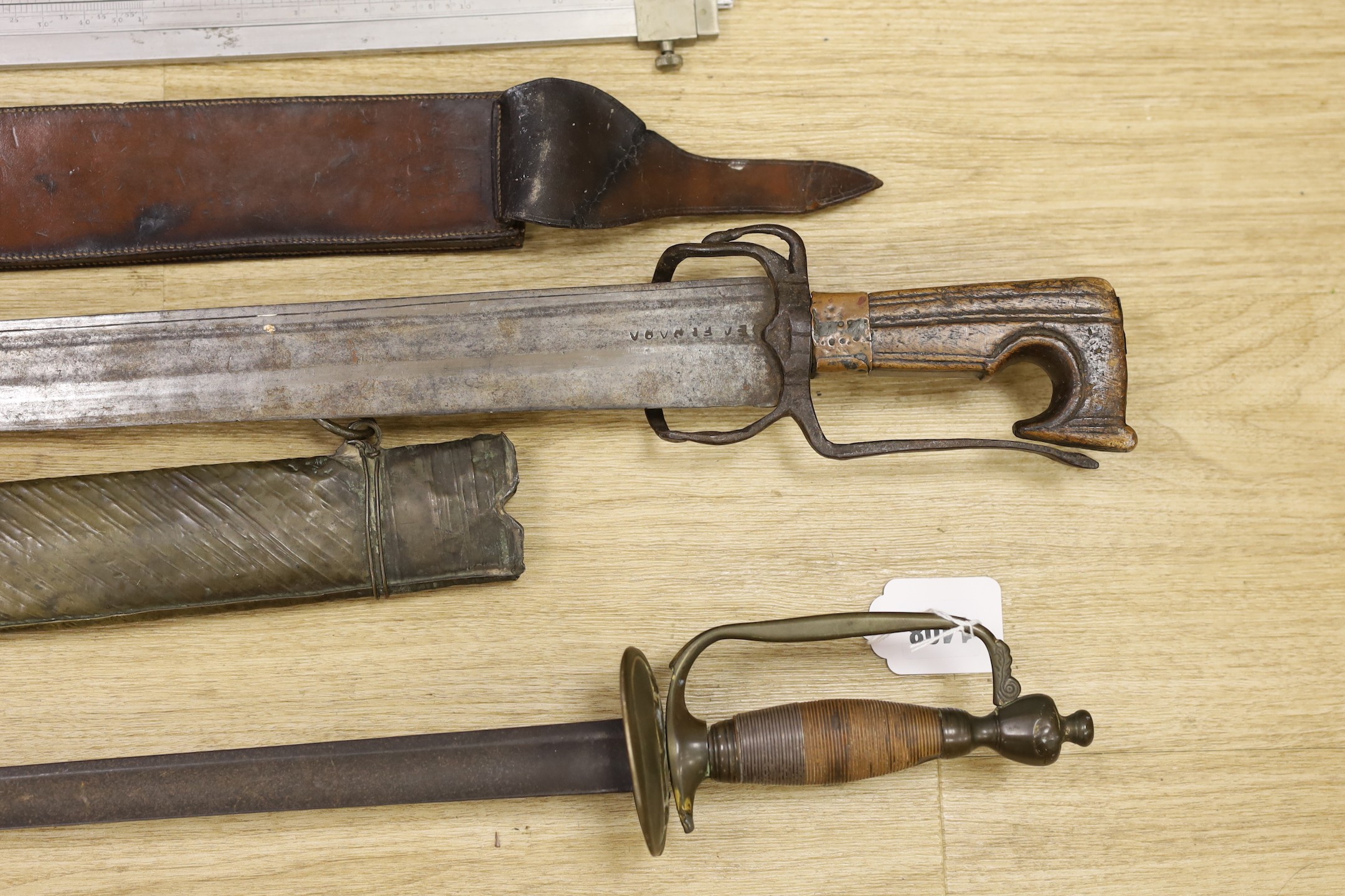 A Moroccan nimcha sword with associated Andrea Ferrara (Scottish) blade and a scabbard together with a court sword and an Aston & Mander Ltd. Mk VI military rule in leather case